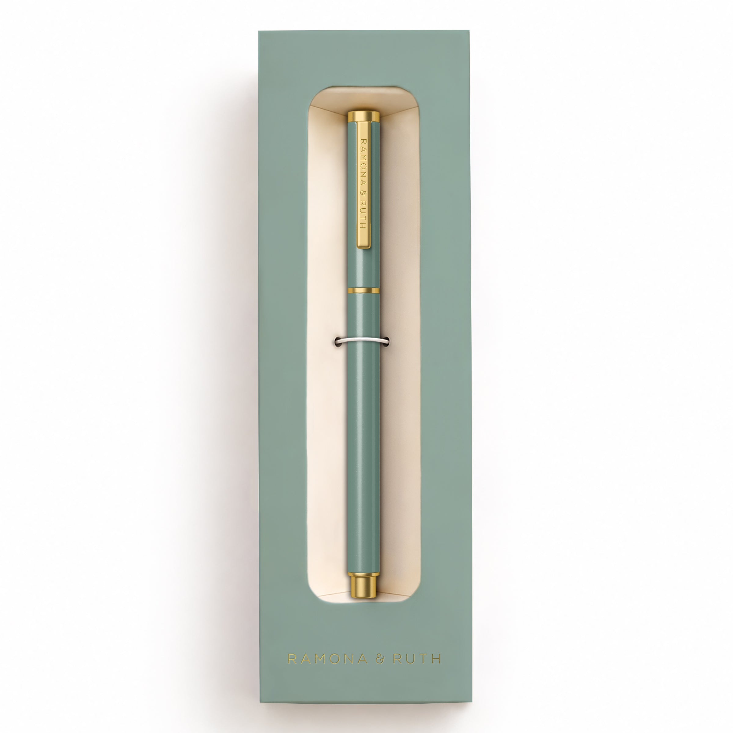 A sage green and gold Ramona & Ruth ballpoint pen presented inside its matching sage green gift box, against a clean white background.